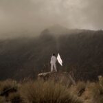 person standing holding a white flag